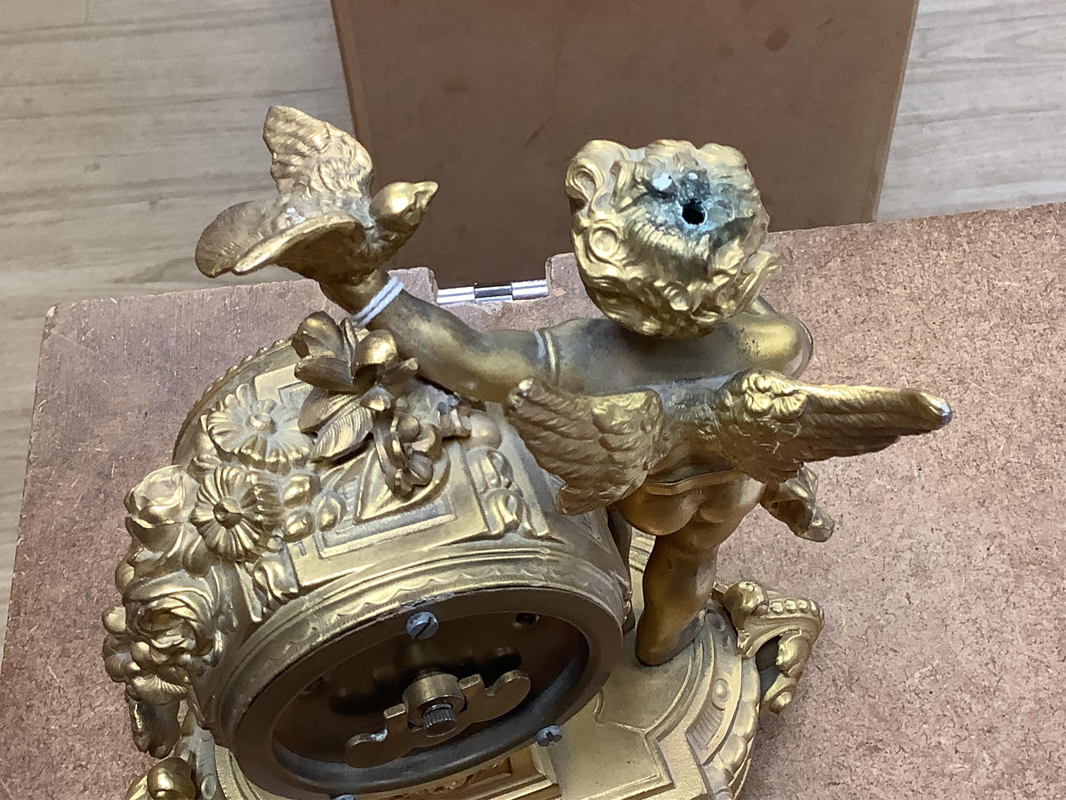 A late 19th century gilt metal cherub timepiece, Ansonia clock company movement, 21cm high